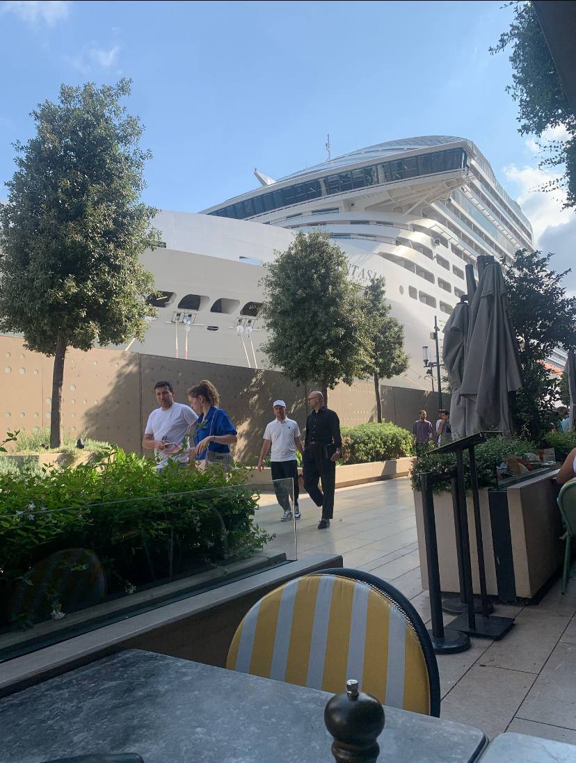 Cruise ship docked at Galataport Istanbul seen from a waterfront café