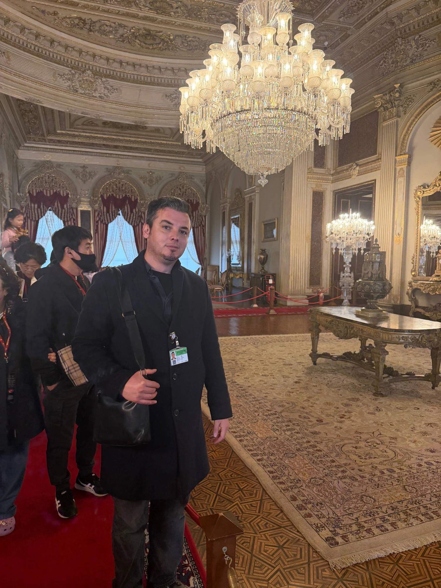 Guide Akın in the chandelier-lit halls of Dolmabahçe Palace, Istanbul
