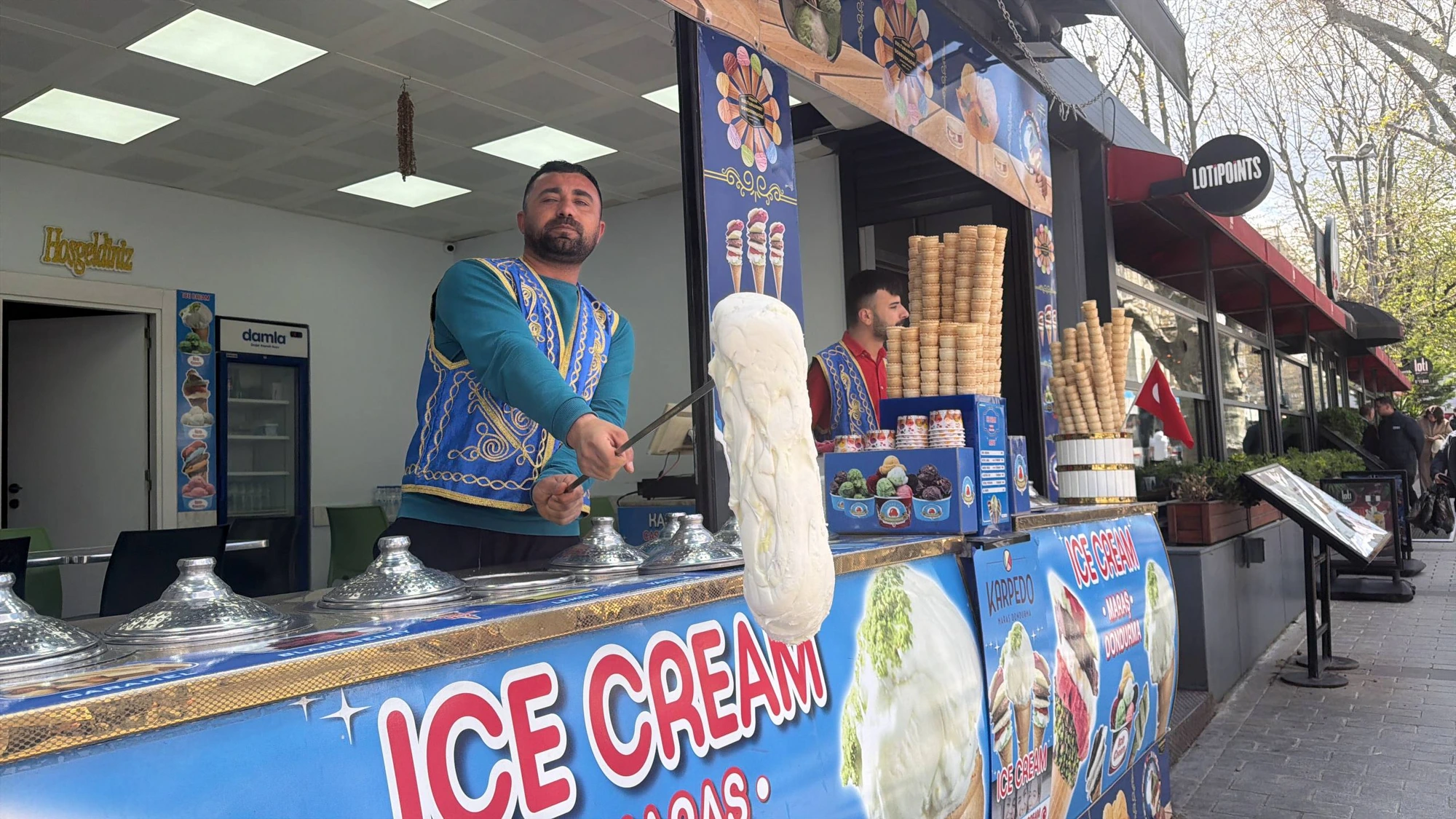 Traditional Maraş ice cream vendor performing for tour guests in Istanbul