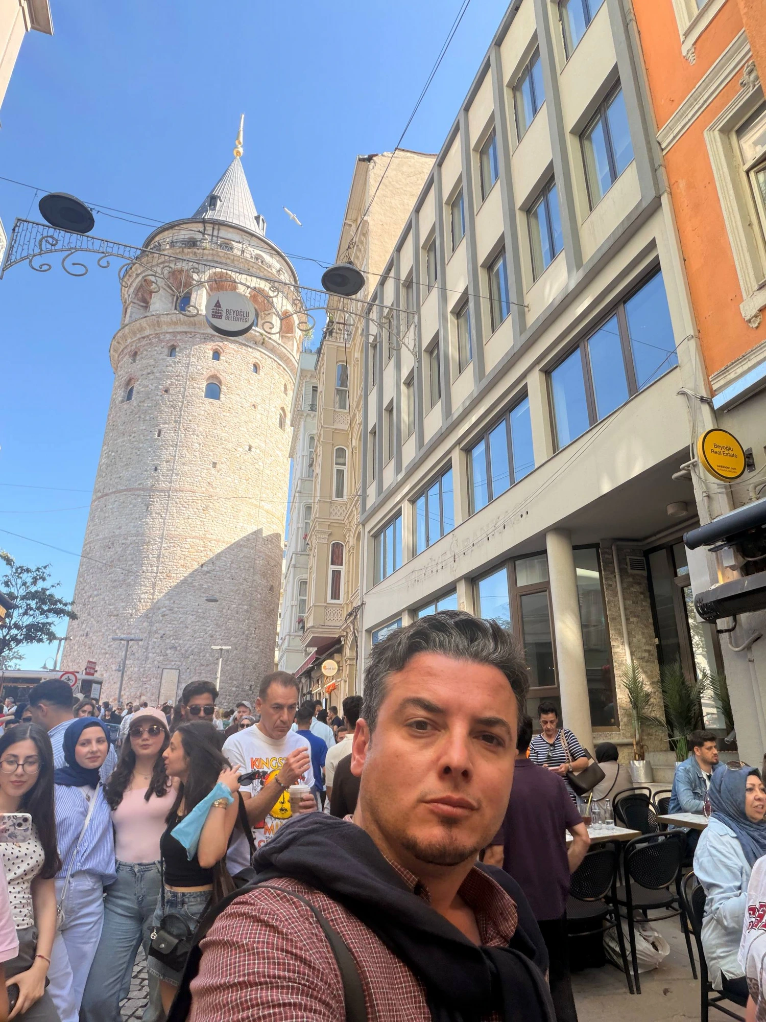 Guide Akın with the Galata Tower rising above the crowds in Beyoğlu, Istanbul