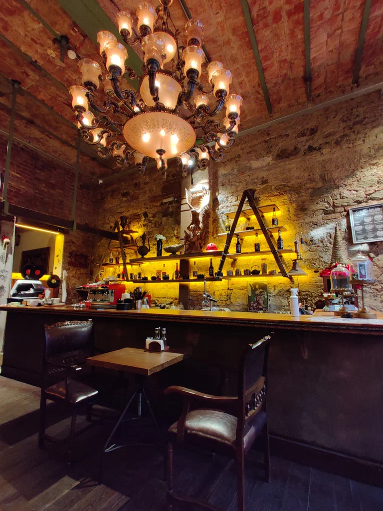 Cozy interior of a small pub near Galataport on Mumhane Caddesi, with warm lighting and vintage decor