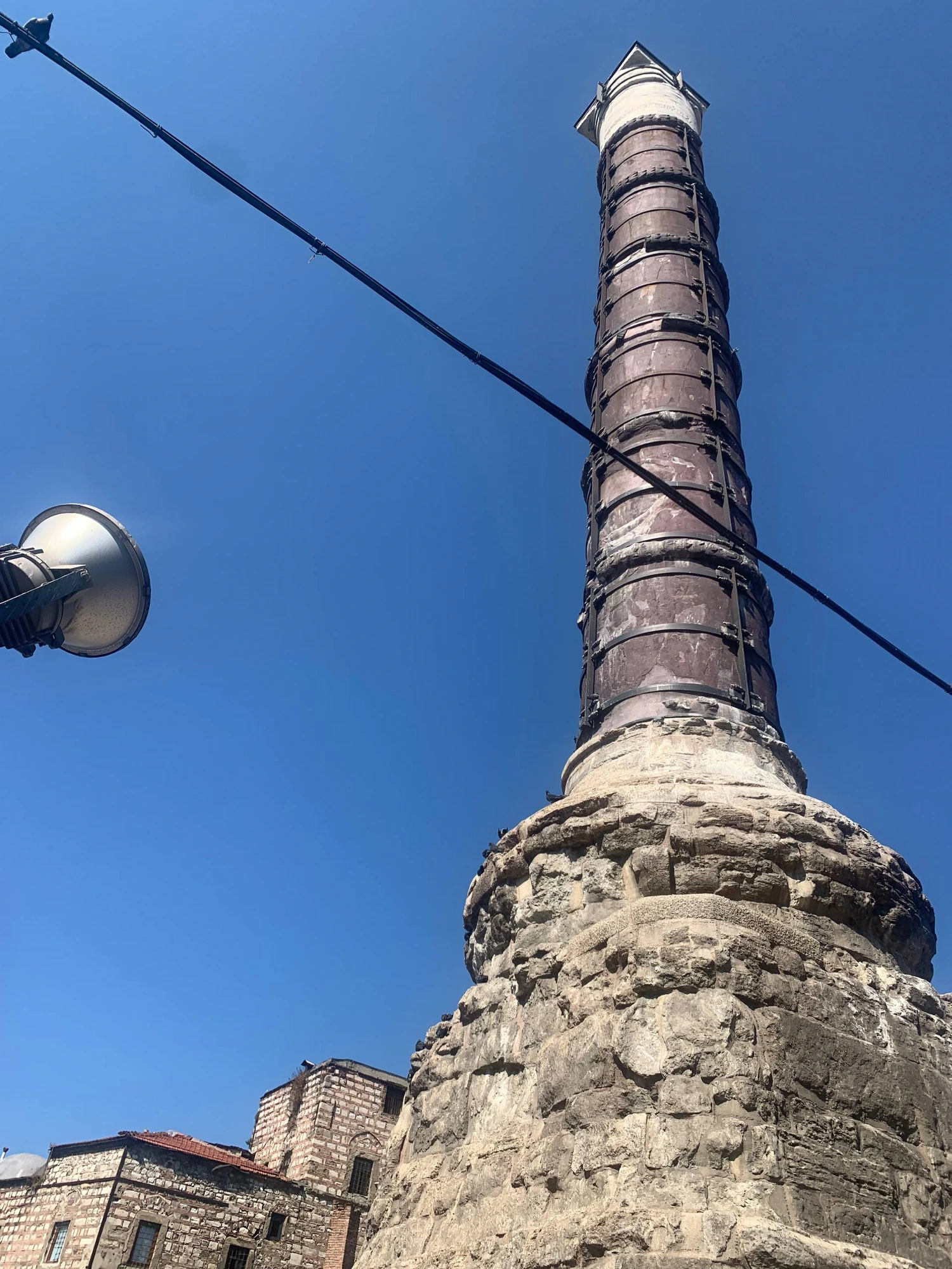 The ancient Column of Constantine (Çemberlitaş) against a blue sky in Istanbul