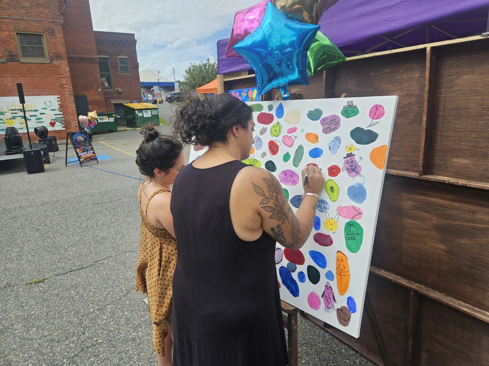 Community members painting together at a GEMS creative event