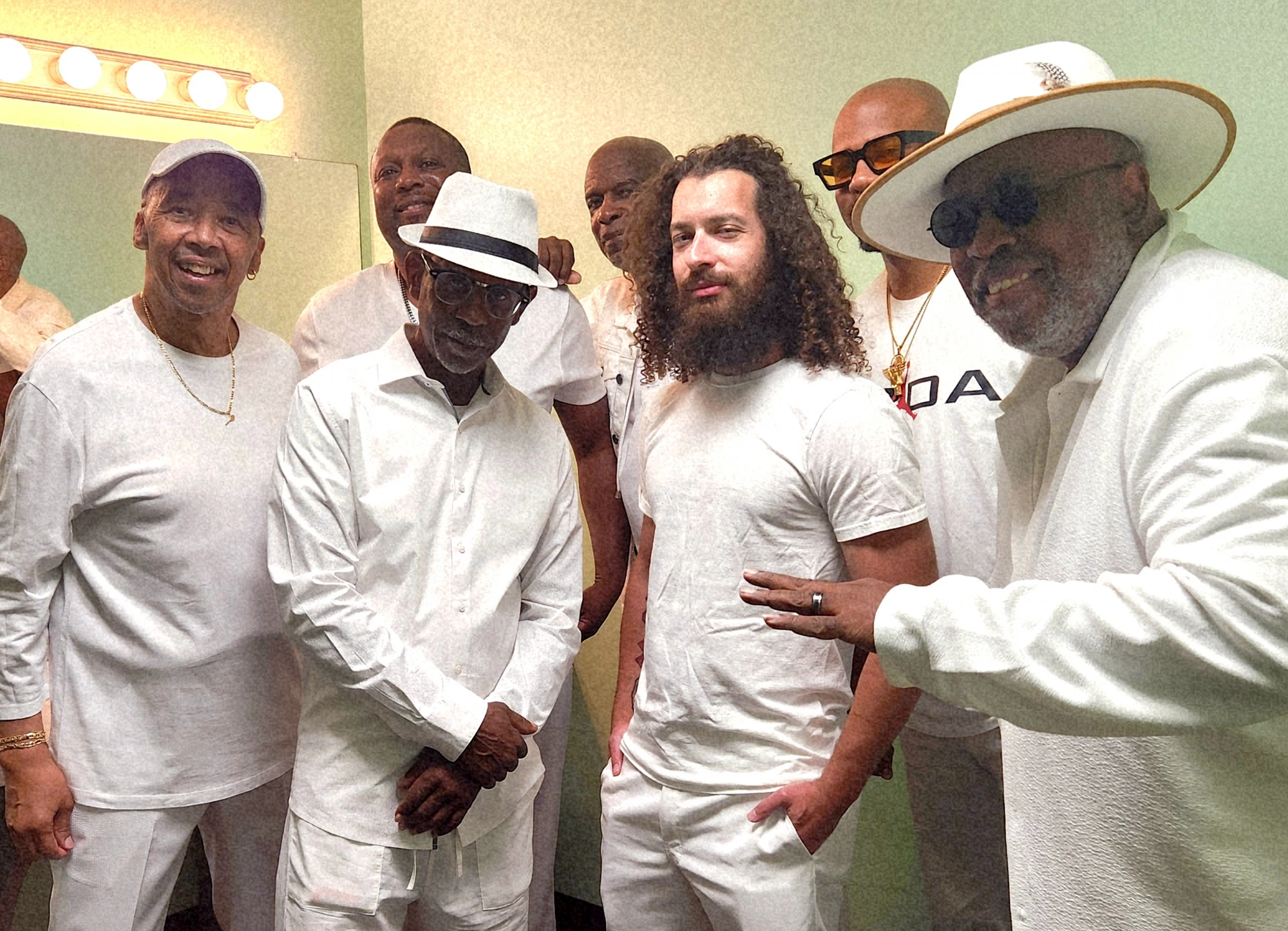 A.T.O.M. band all in white backstage in the dressing room
