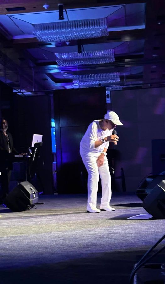 Band member in a white suit backstage in the dressing room