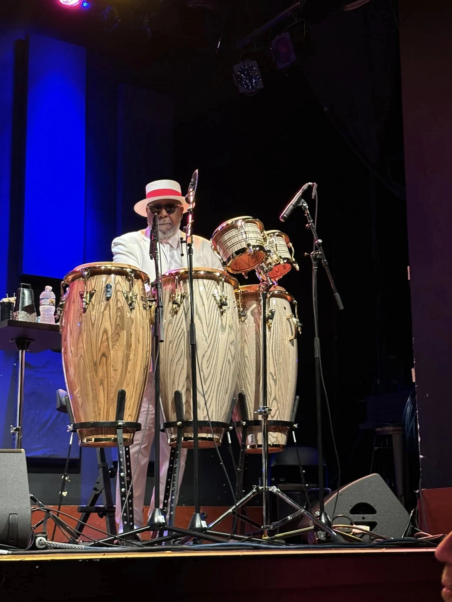 Percussionist in a white hat behind the congas