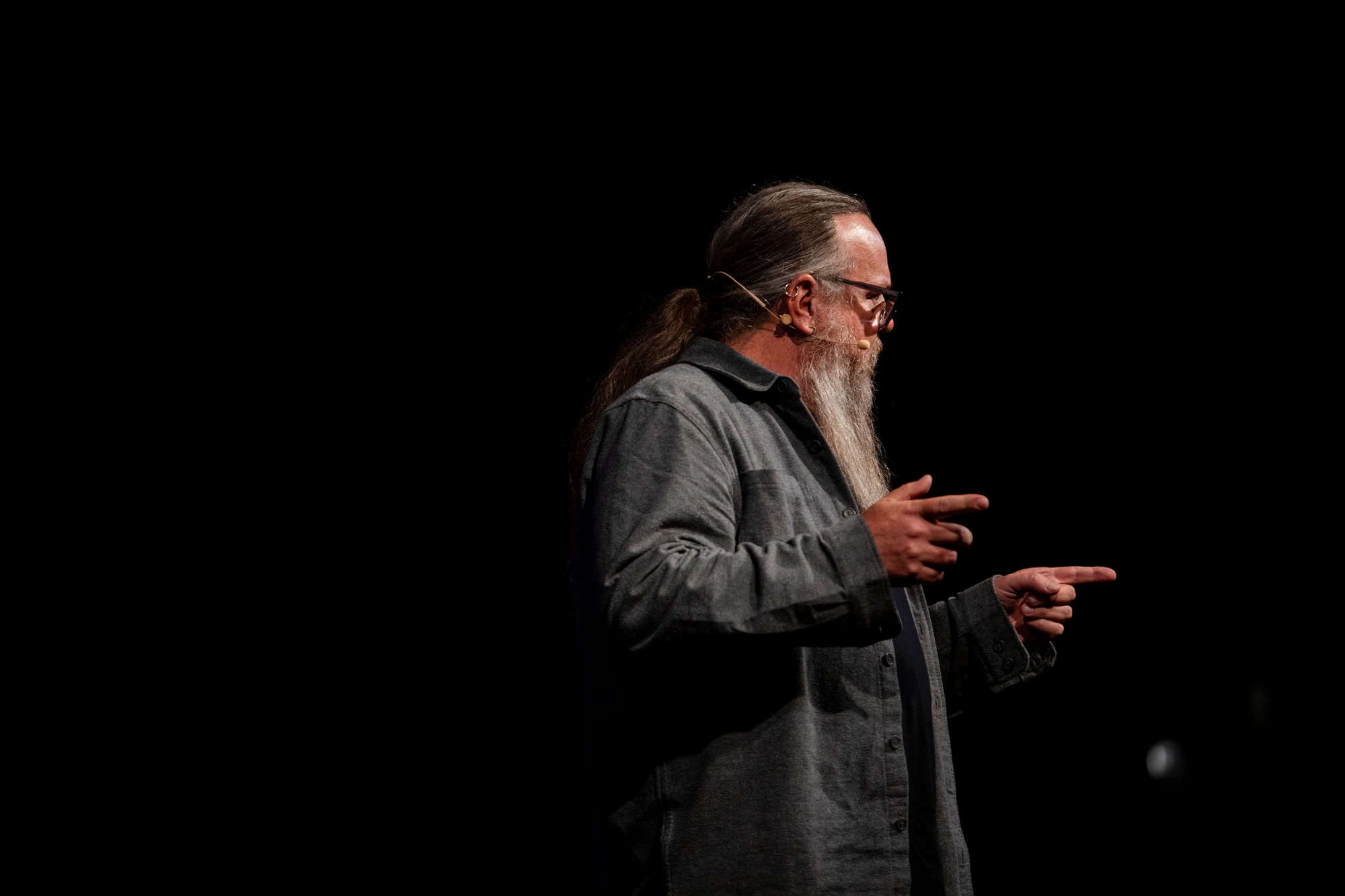Iain DeJong mid-gesture on stage