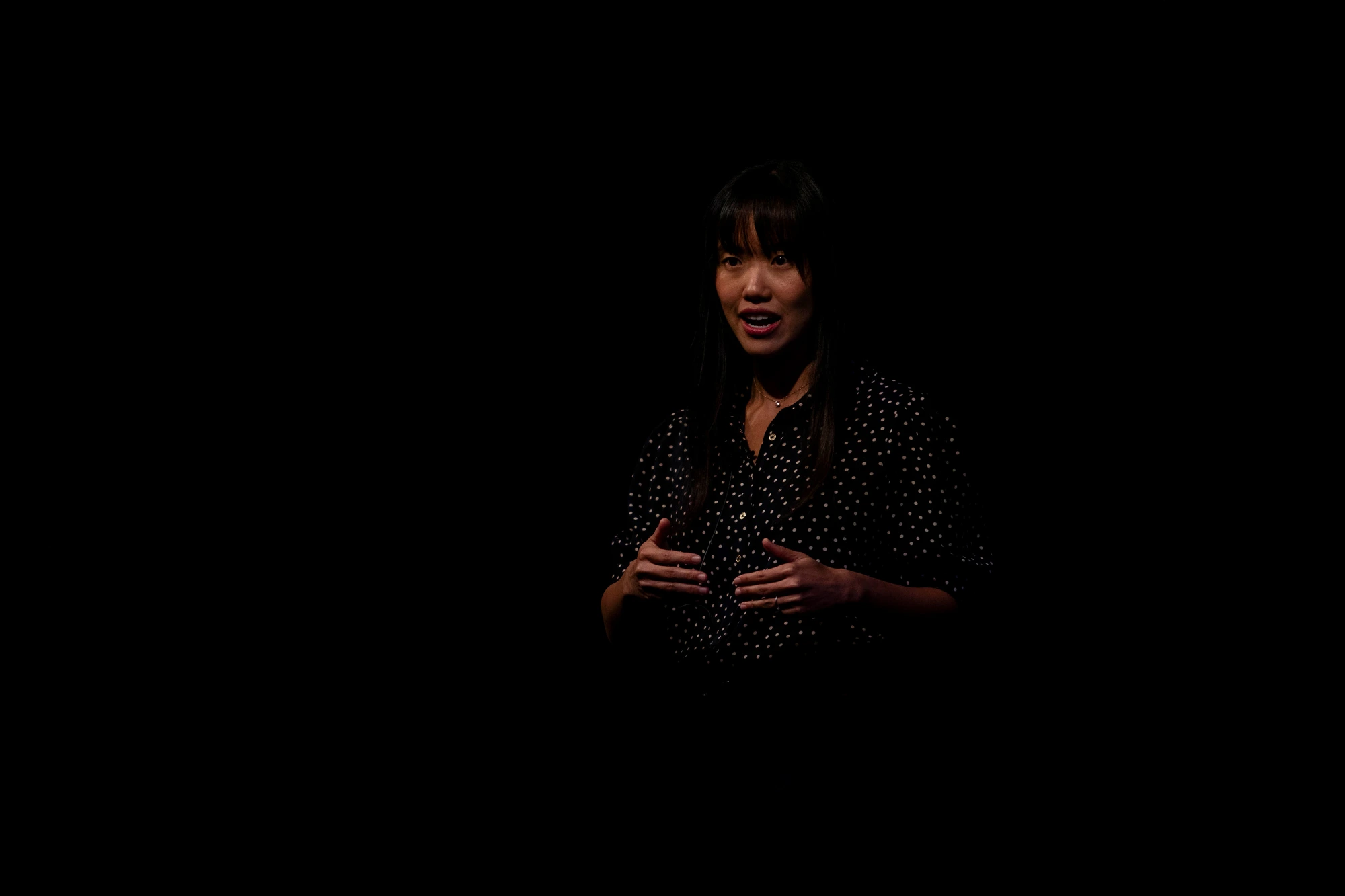 Annie Meng addressing the room on stage