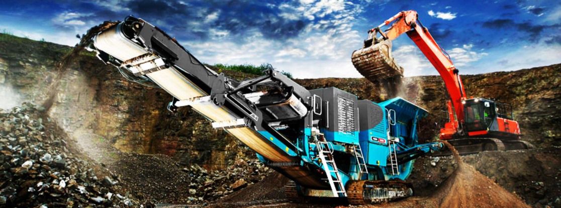 Mobile crushing plant and excavator working an open-pit face — heavy mining equipment in operation