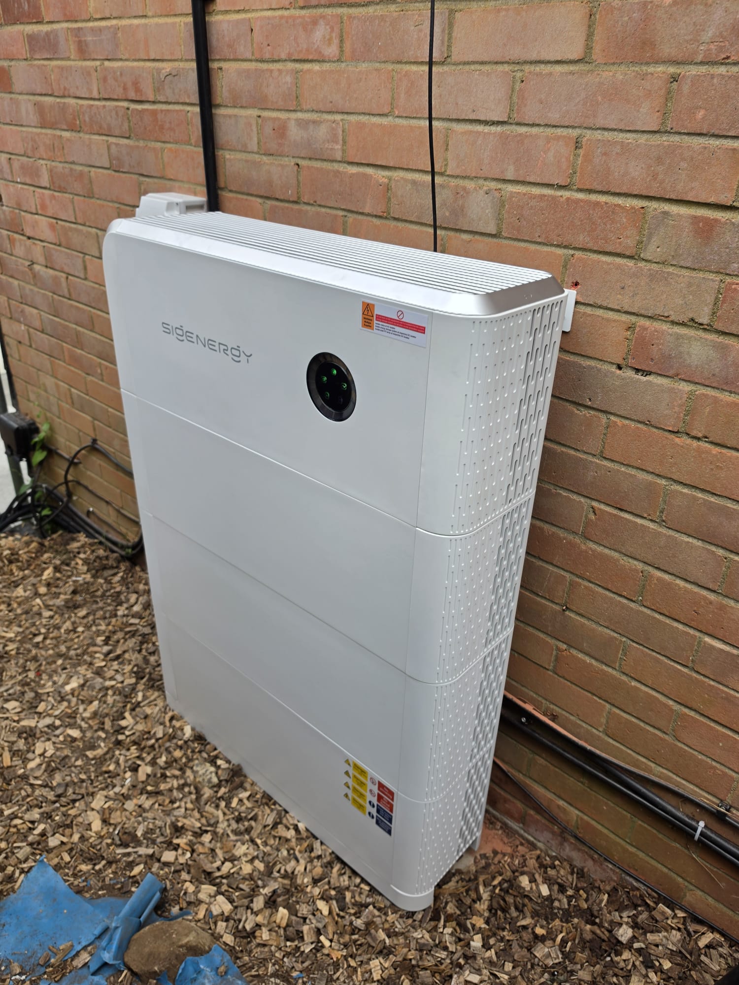 SigEnergy battery storage unit mounted on brick wall