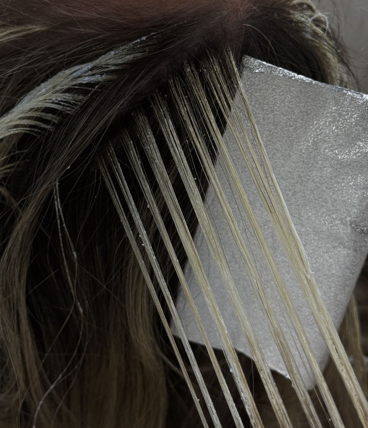 Foil highlights being placed on hair