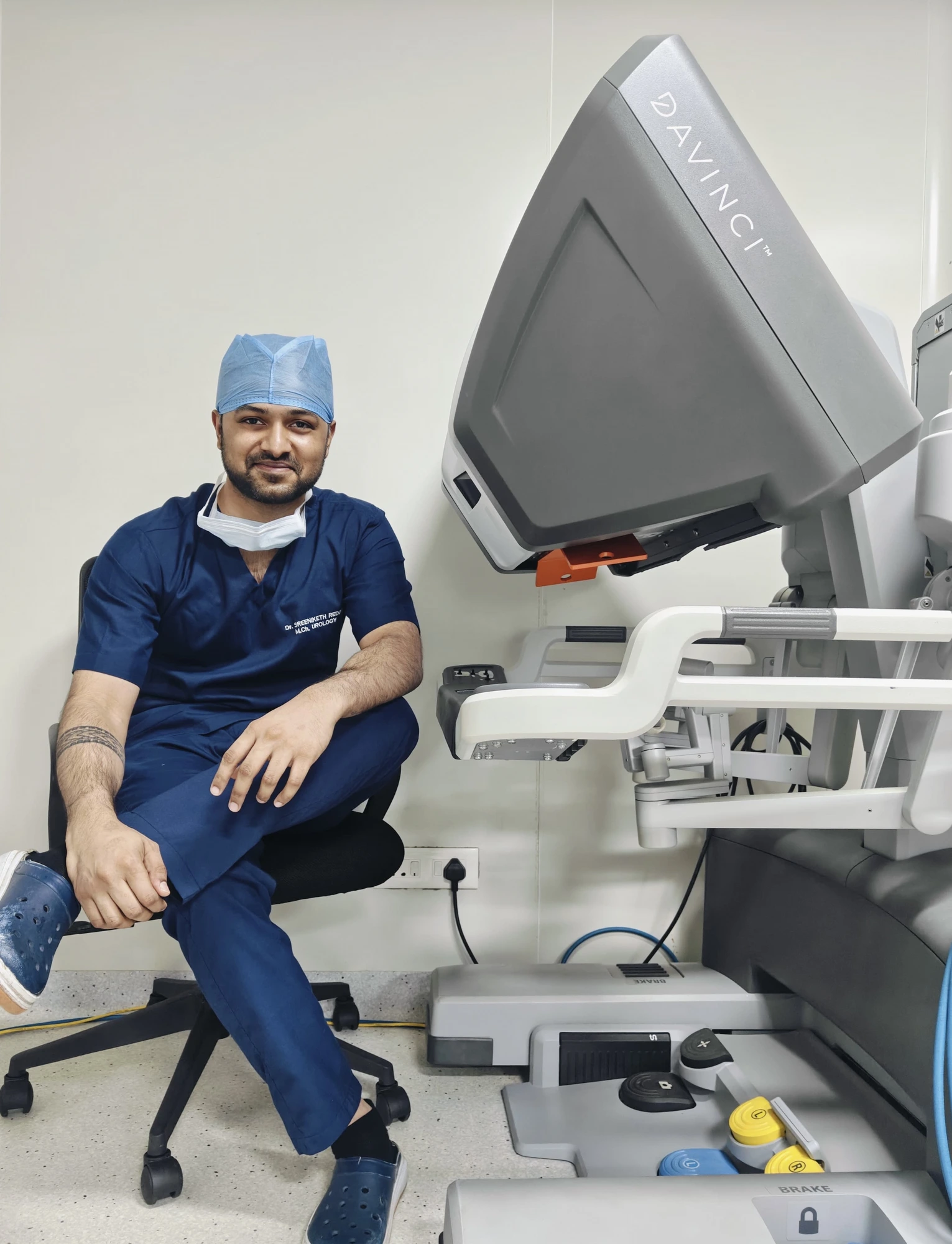 Dr. Sreeniketh Reddy with a robotic surgery system