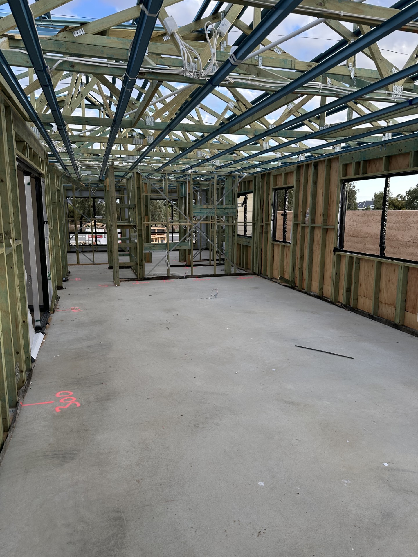 Interior timber wall and roof framing on a concrete slab